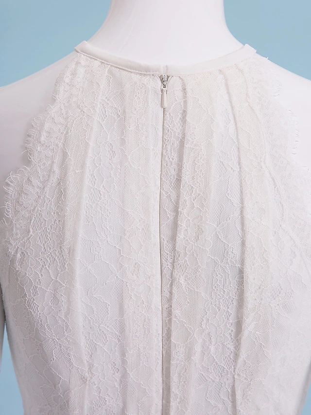 Full length view of the wedding dress, emphasizing the floor-length hem and flowing chiffon.