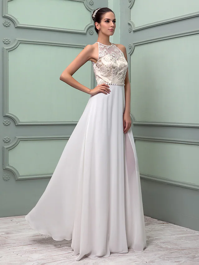 Close-up of the jewel neckline and delicate beading on a bridal gown.