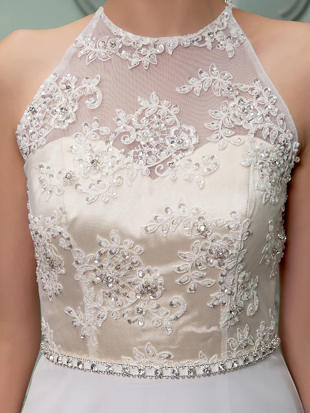 Bridal gown featuring a jewel neck, beading, and a stylish front split.