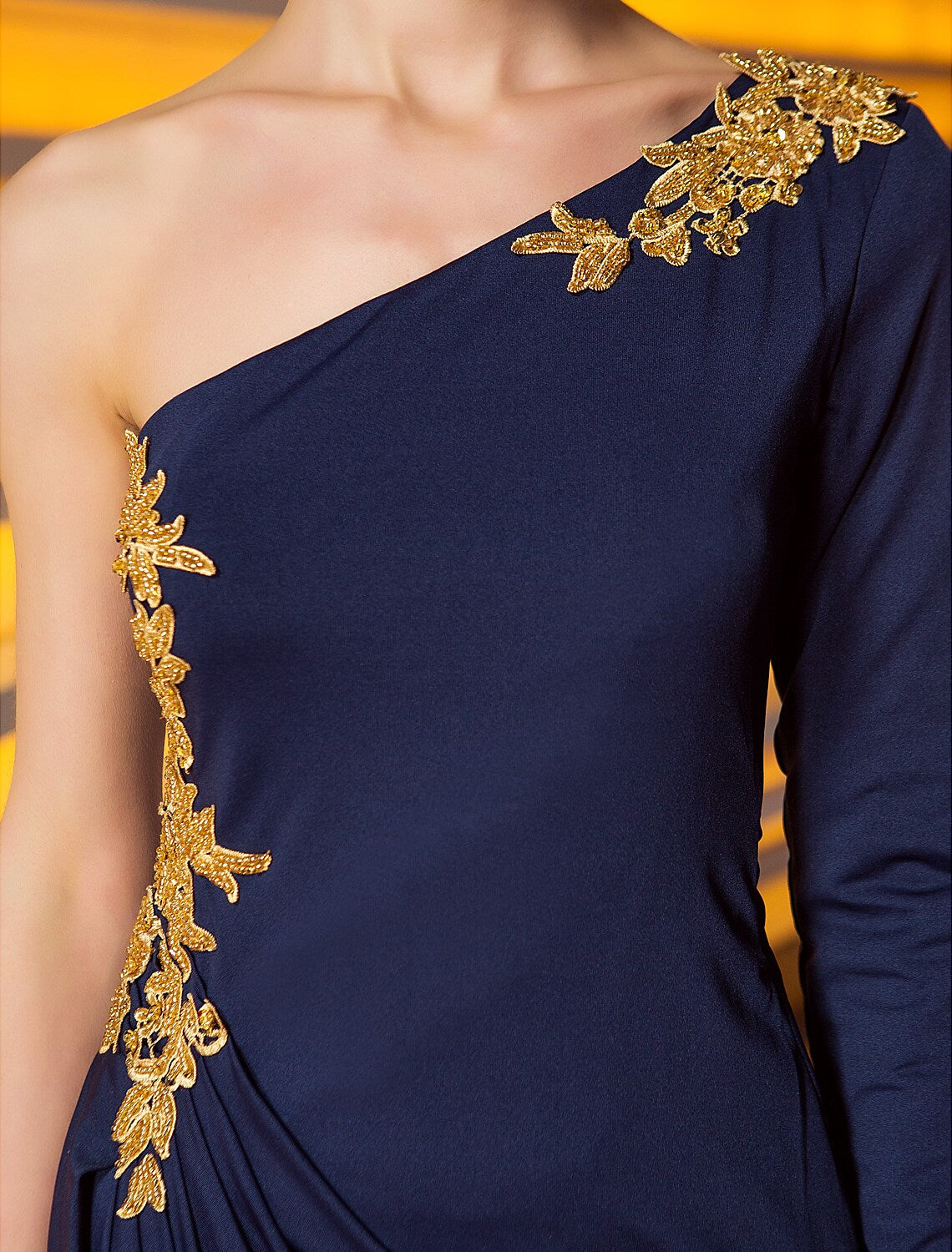 Back view of the ankle-length jersey evening gown with draped details.