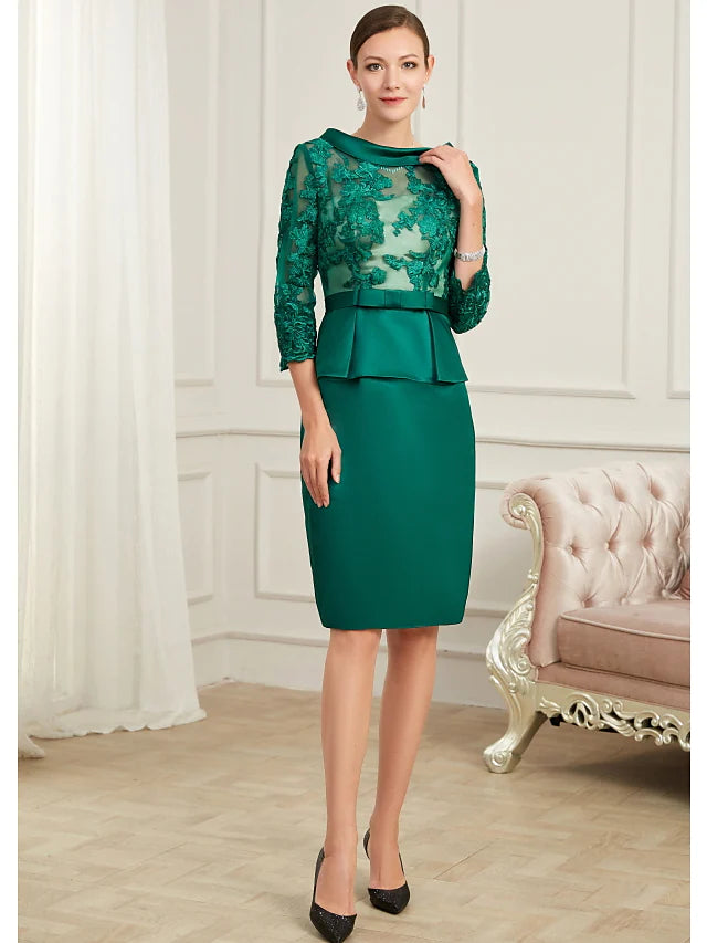 Back view of the knee-length chiffon dress with peplum detail.