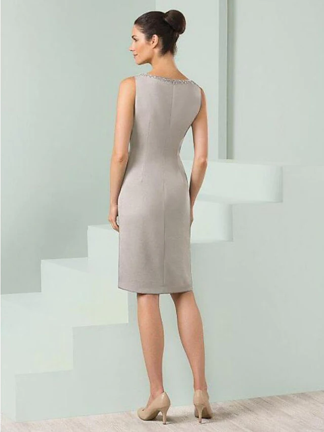 Navy satin Mother of the Bride dress with knee-length hem and beaded details.