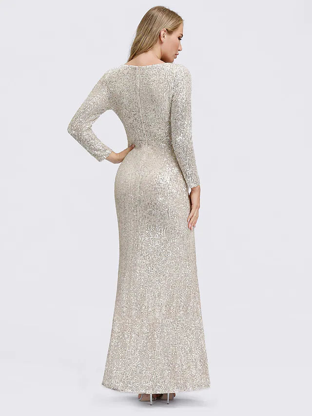 Side view of a woman wearing a long sleeve sequined evening gown.