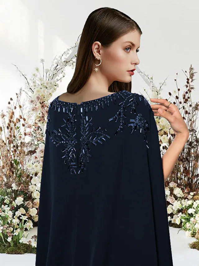 Back view of a model in a sleeveless stretch chiffon prom dress with a flowing sweep train.
