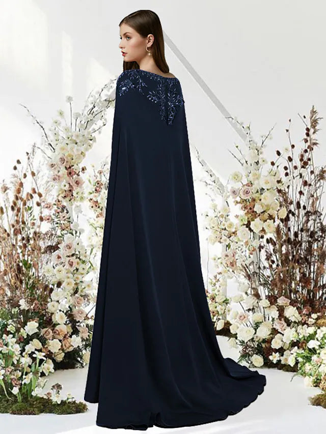 Side profile of a model showcasing the empire waist and beaded details of a sheath prom gown.