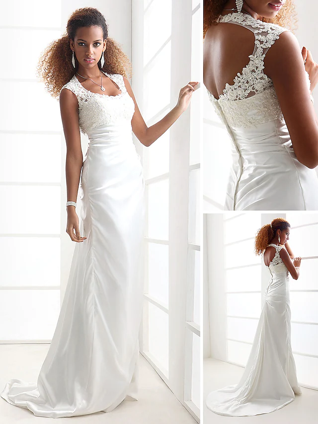 Close-up of the intricate beaded lace and applique details on the wedding dress bodice.