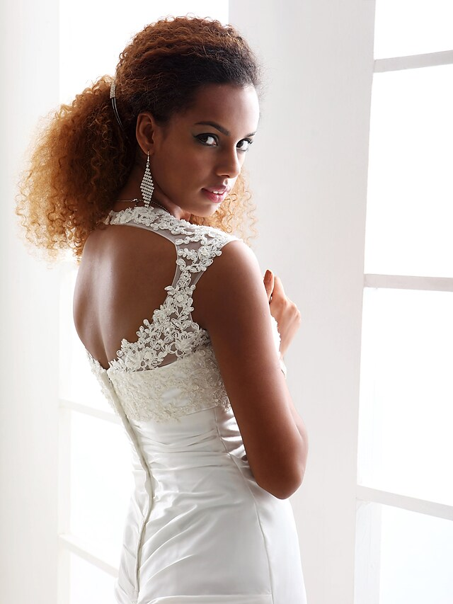 Full length view of the elegant wedding dress, highlighting its sheath silhouette.