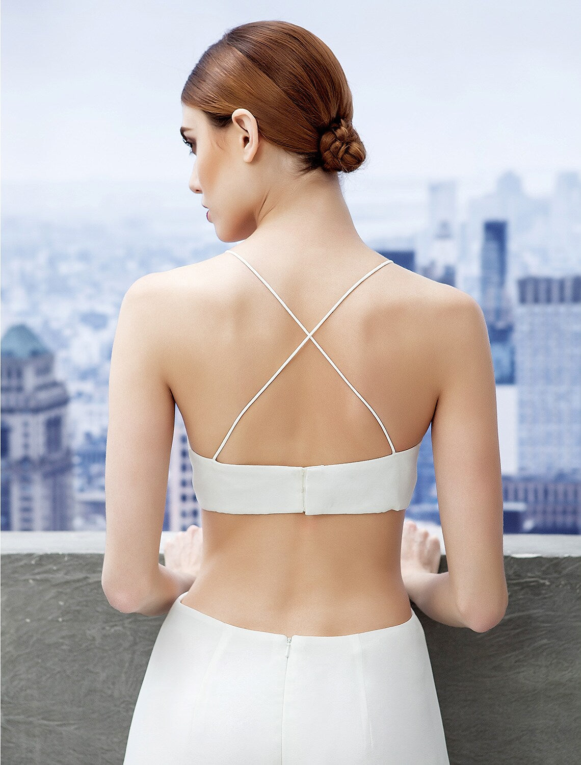 Model wearing a floor-length formal dress with spaghetti straps.