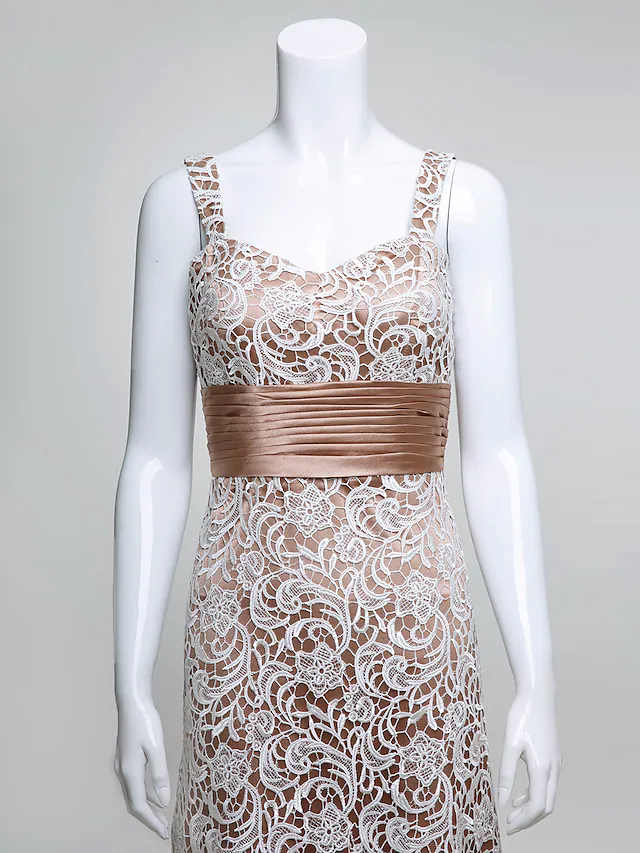 Close-up of the V-neckline and intricate lace detailing on the bodice of the dark blue dress.