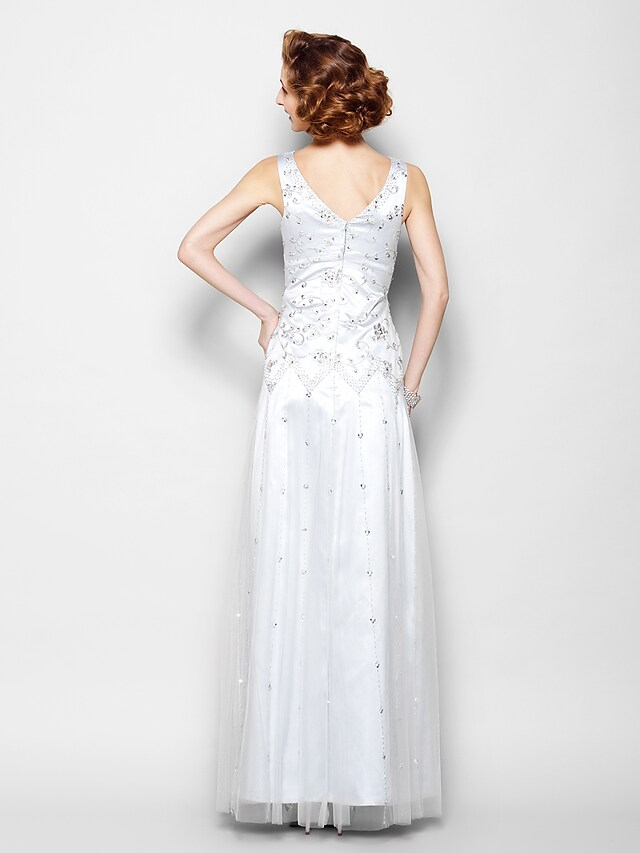 Close-up of the V-neckline and intricate lace beading on the dress.