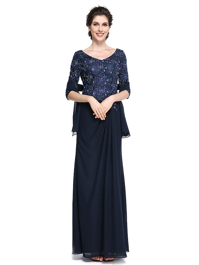 Woman wearing an elegant V-neck, half-sleeve, ankle-length Mother of the Bride dress with lace details.
