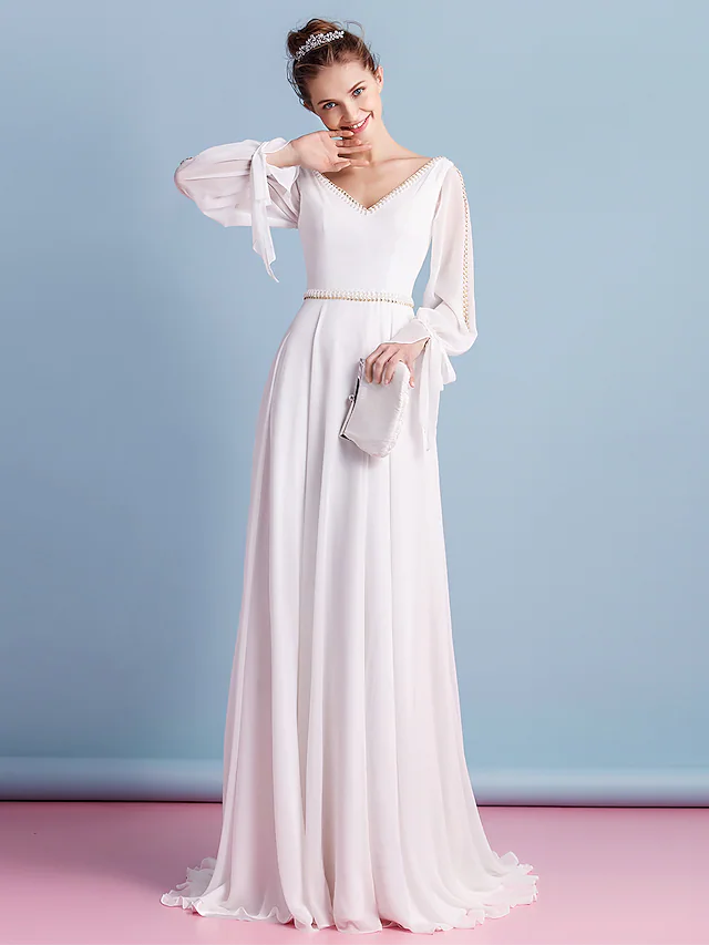 Elegant V-neck chiffon wedding dress with long sleeves and beading.
