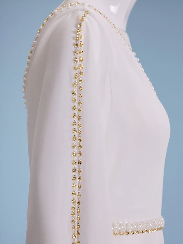 Side view of a bridal gown with a flowing court train.