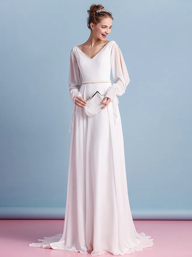 Close-up of the V-neckline and intricate beading on the chiffon dress.