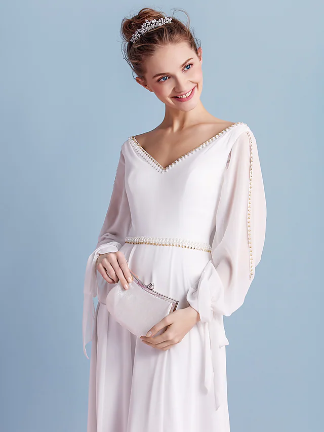 Model showcasing the long sleeves and V-neck of the wedding dress.