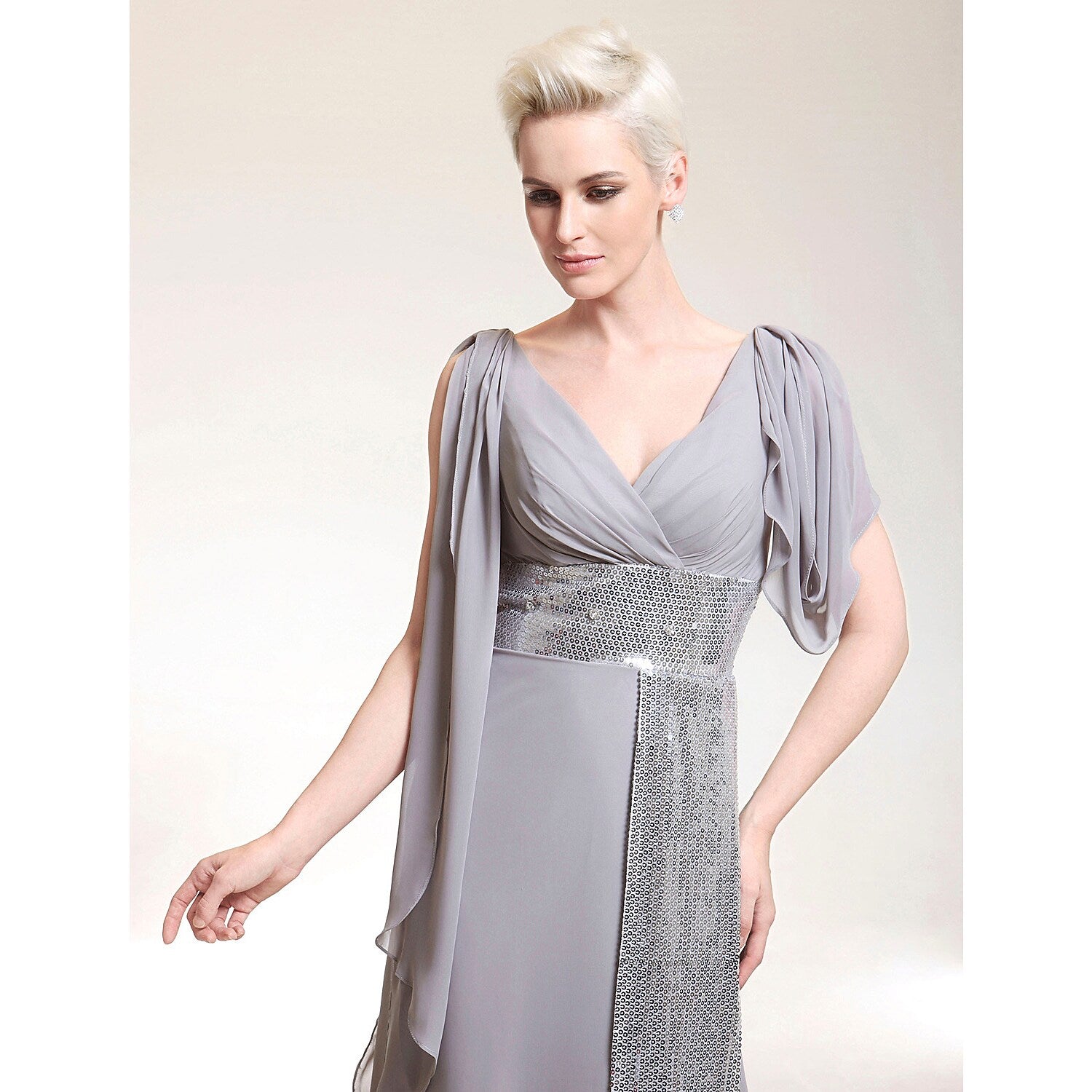 Side view of a celebrity-style floor-length dress featuring intricate beading.