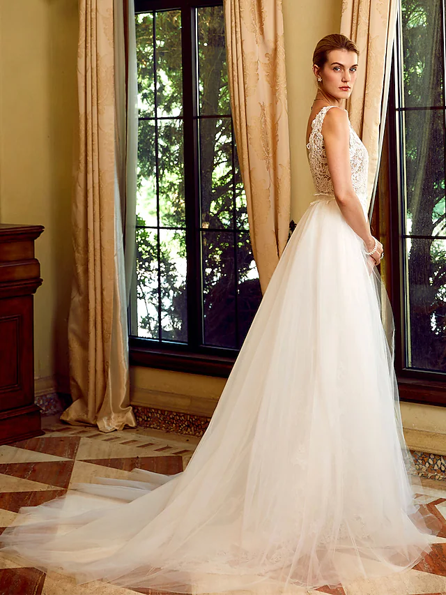 Back view of the wedding dress, showcasing the chapel train and regular straps.
