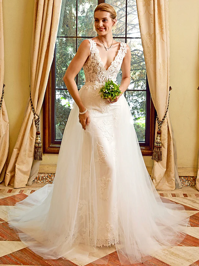 Side profile of the bride wearing the sheath wedding dress, highlighting its silhouette.