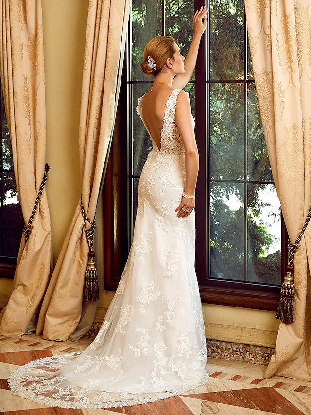 Detail of the sheer tulle fabric and intricate appliques on the wedding gown.