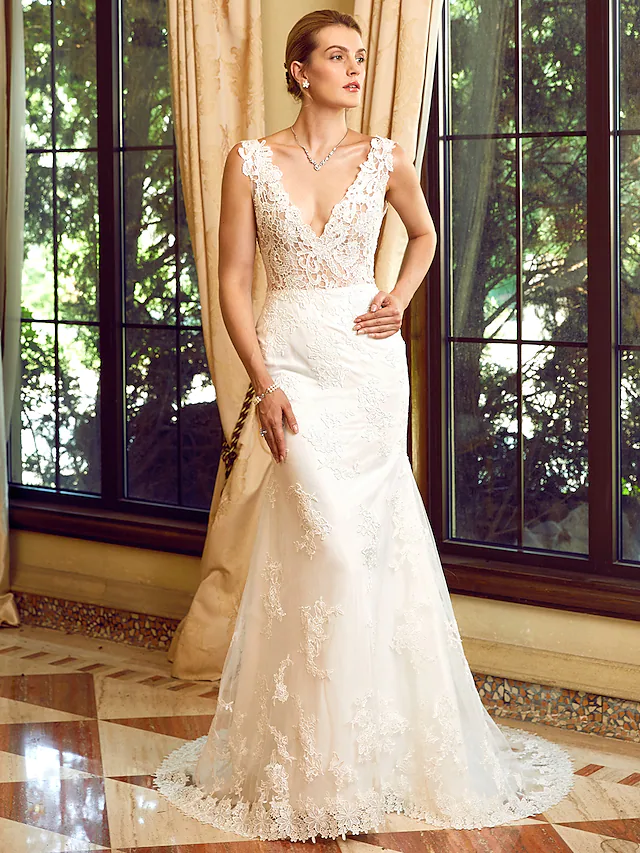 Full length view of the wedding dress, emphasizing the graceful flow of the chapel train.