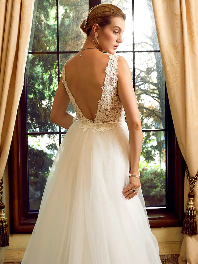 Close-up of the lace and applique details on the bodice of the wedding dress.
