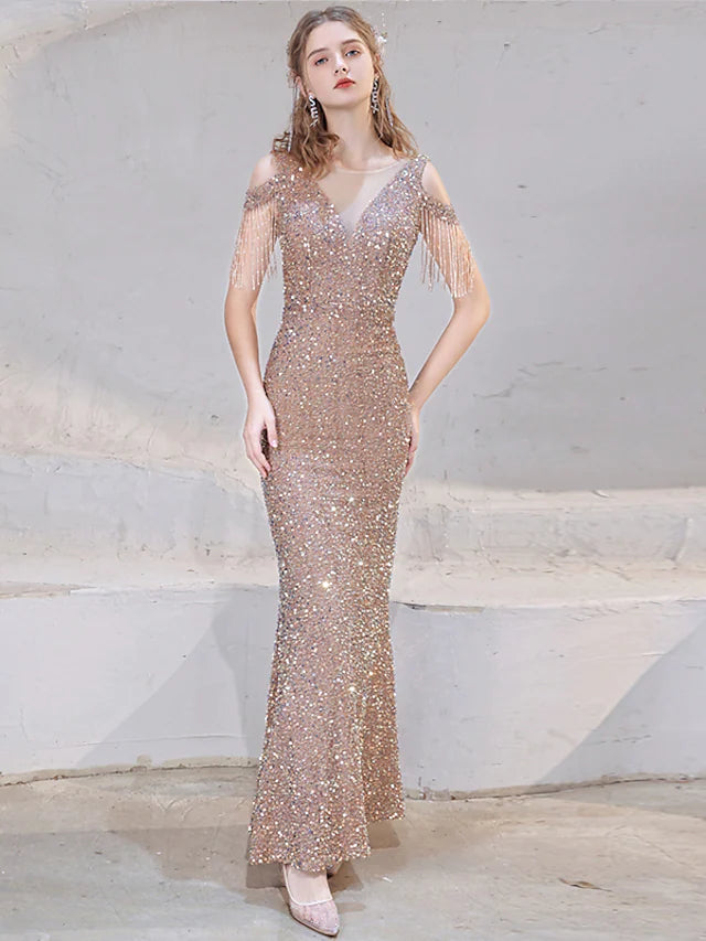 Full-length view of a woman wearing a sparkly mermaid wedding guest dress.