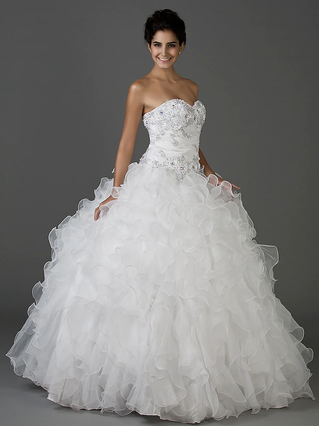 Close-up of the sweetheart strapless bodice of the white wedding gown.