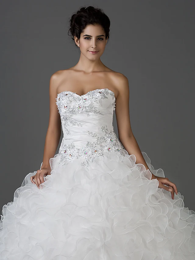 Detail of the shimmering fabric and embellishments on the wedding dress.