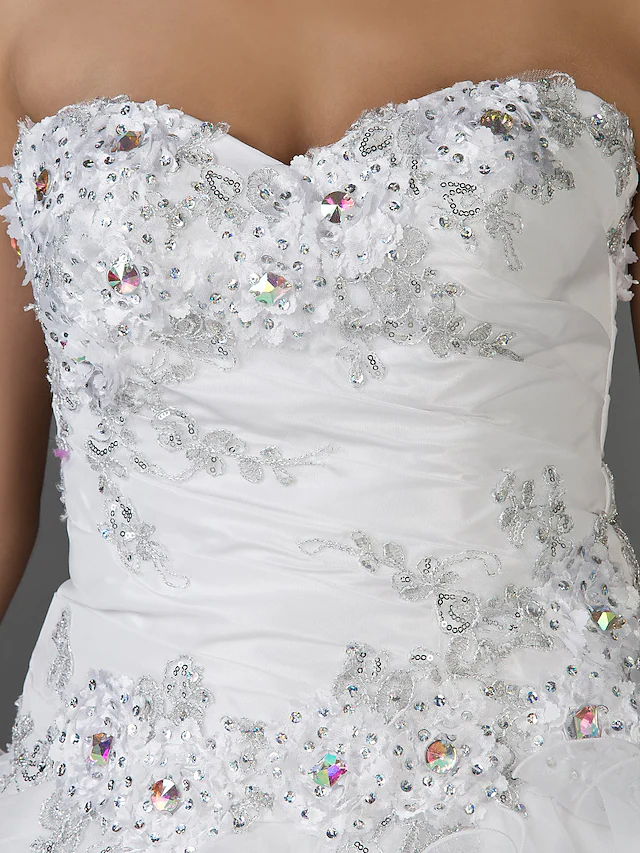 Full length view of the white organza and taffeta ball gown wedding dress.