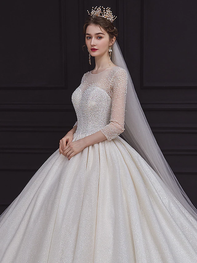 Full length view of a bride wearing the romantic long sleeve wedding dress.