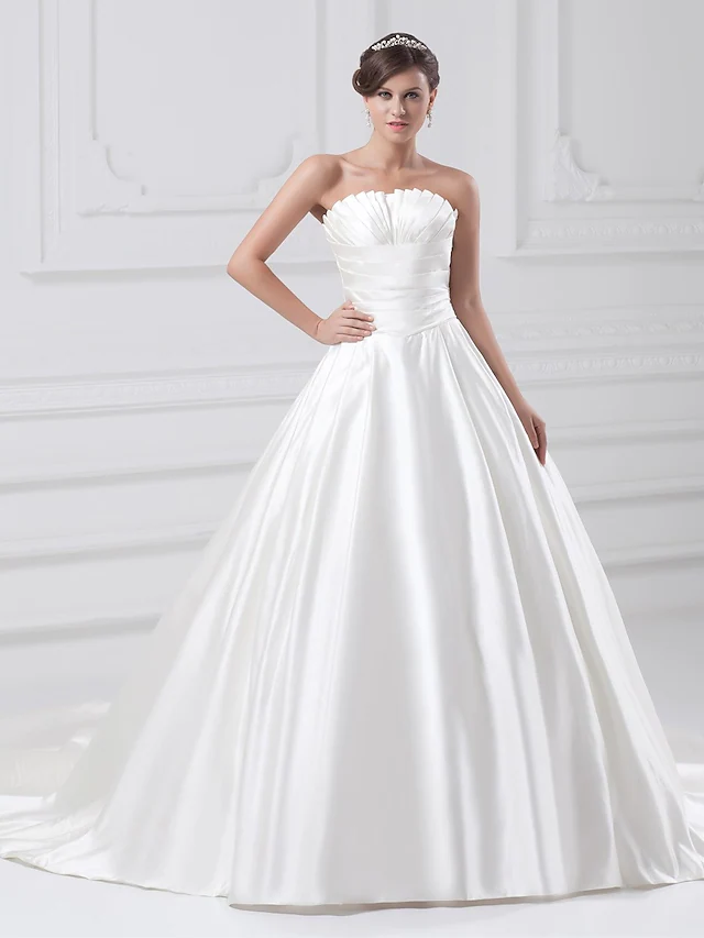 Elegant strapless satin ball gown wedding dress with ruched bodice and court train.