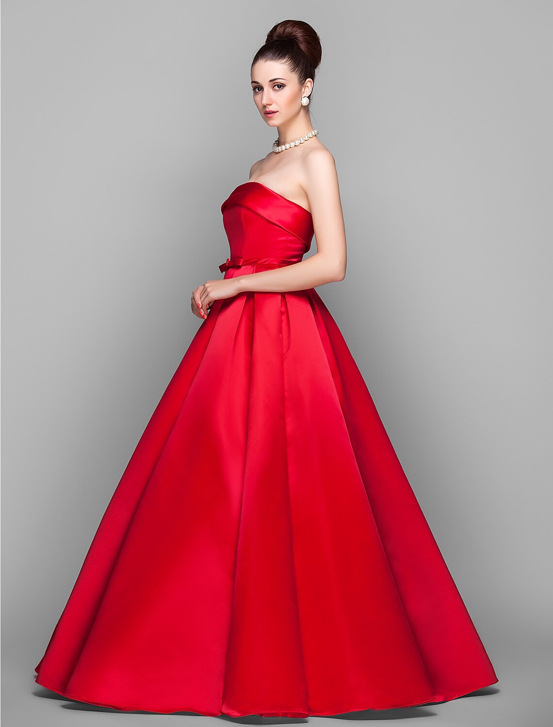 Back view of the elegant strapless ball gown with a prominent bow.