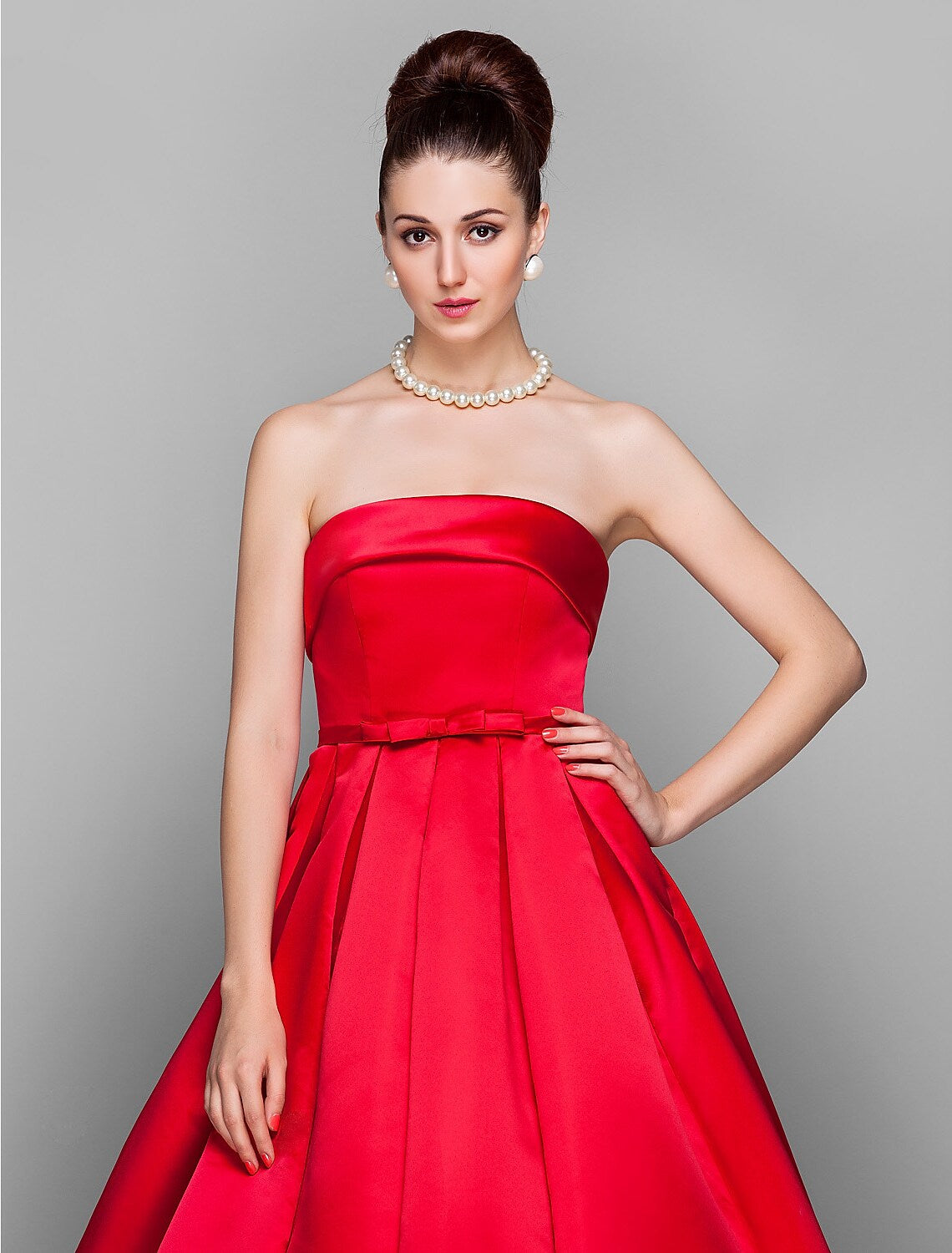 Close-up of the strapless bodice and bow embellishment on the ball gown.