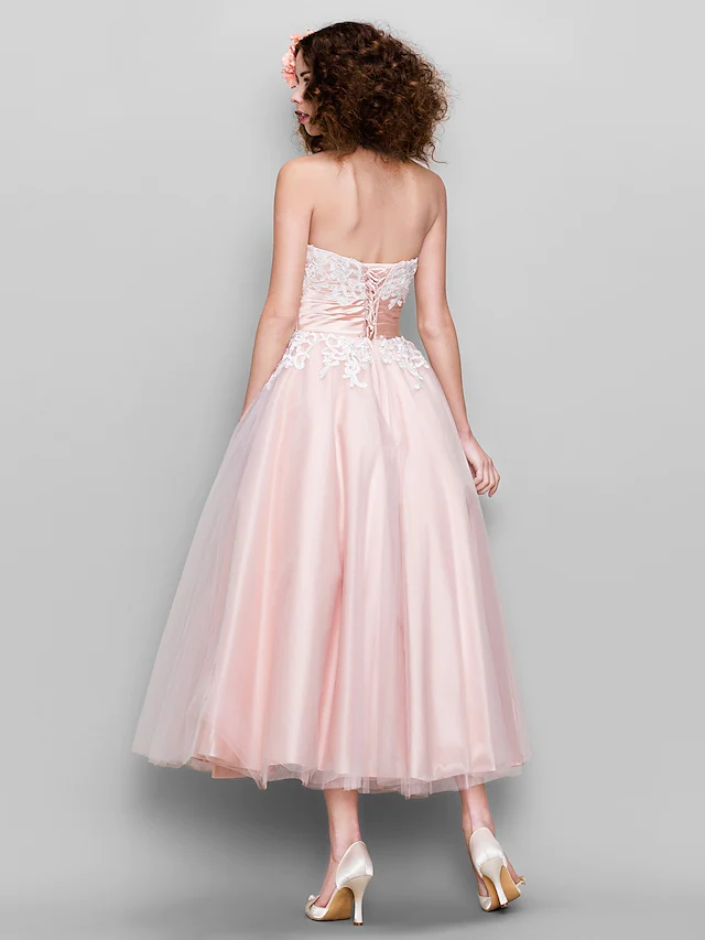 Close-up of appliques on tulle and satin dress.
