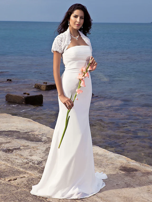 Back view of a strapless mermaid wedding gown with a sweep train.