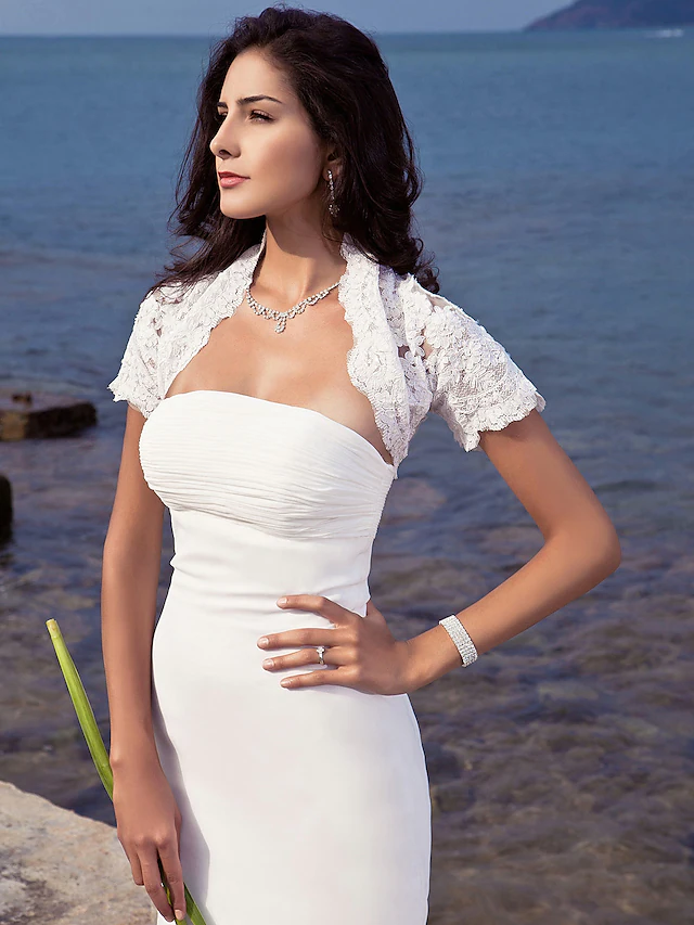 Full length view of a bride wearing a strapless mermaid wedding dress.