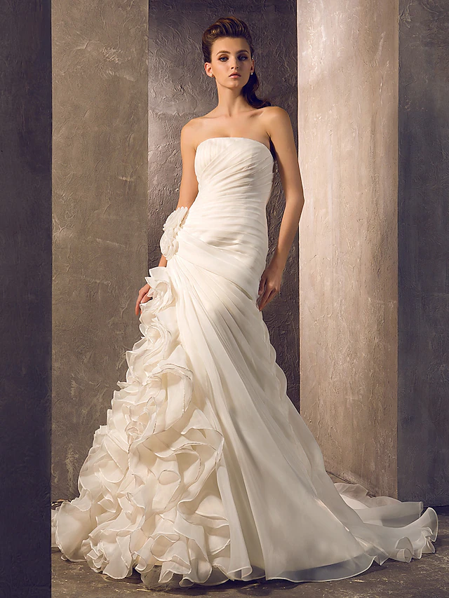 Full view of an elegant strapless organza wedding gown with cascading ruffle and court train.