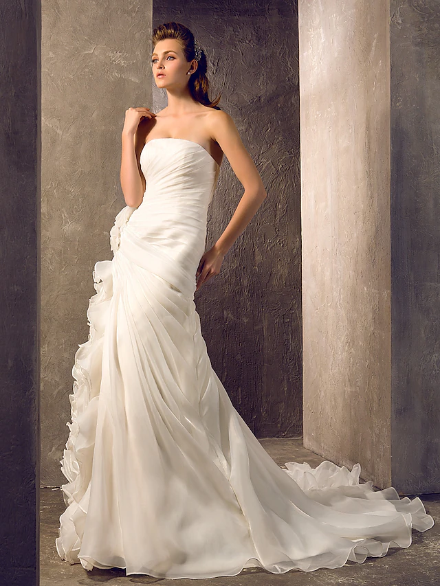Back view of the elegant wedding dress, showcasing its romantic court train.