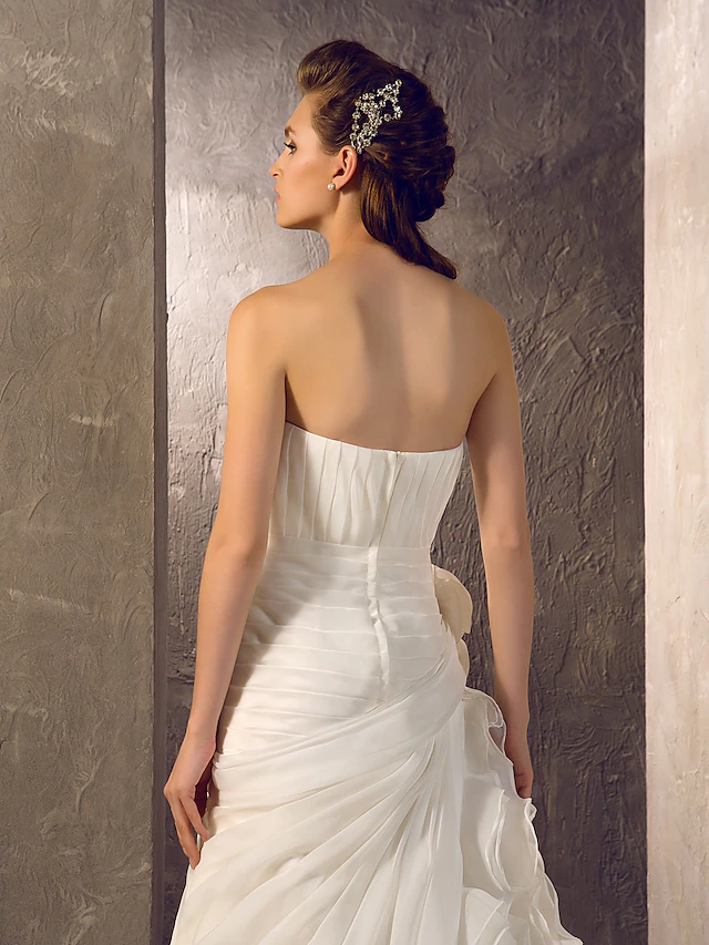 Full length view of the wedding dress, highlighting its elegant design and flow.