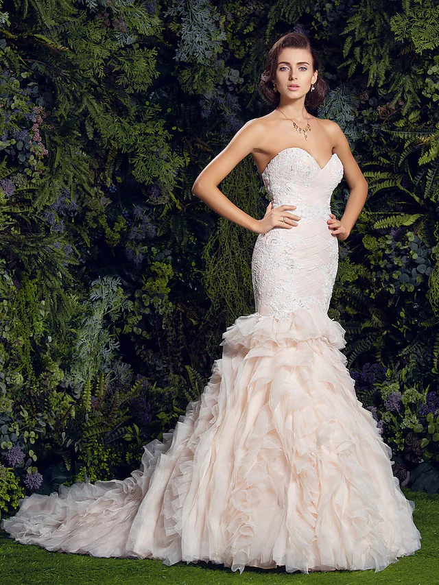 Elegant strapless sweetheart mermaid wedding dress with lace appliques.