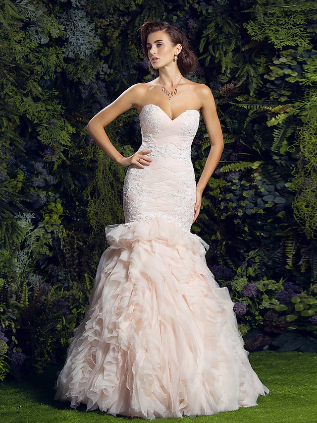 Side profile of a bride in a sweetheart neckline wedding dress.
