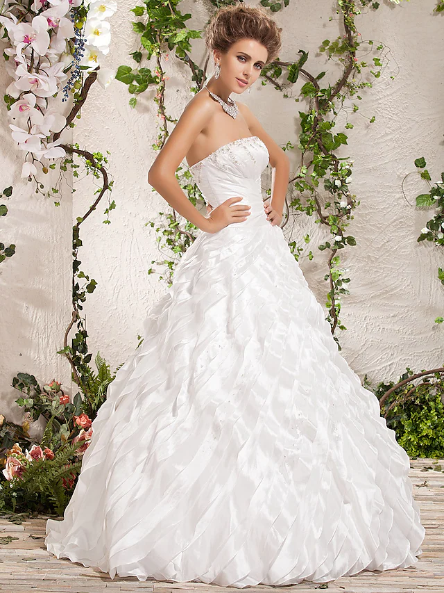 Close-up of beading and cascading ruffle detail on wedding gown.