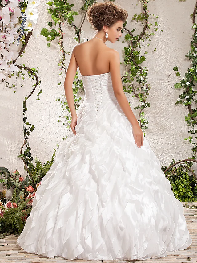 Side view of floor-length ball gown wedding dress.
