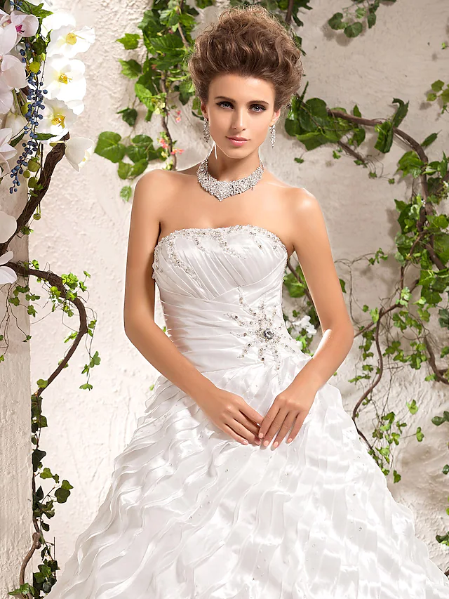 Full view of the elegant strapless wedding dress.