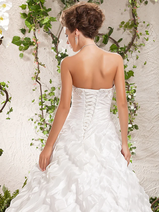 Model wearing the strapless ball gown wedding dress.