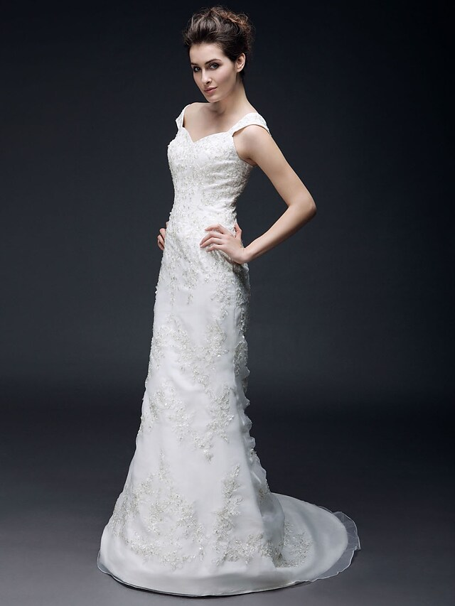 Side view of a bride in a mermaid trumpet wedding gown.
