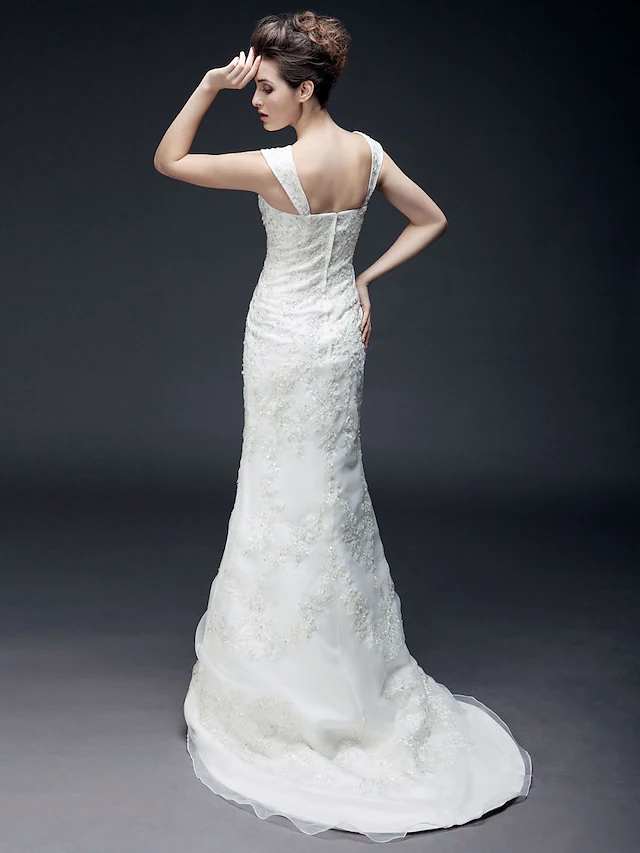 Close-up of the sweetheart neckline and short sleeves on a wedding dress.