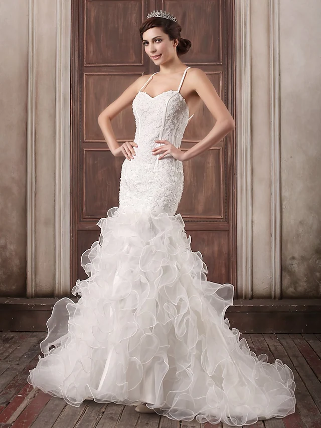 Elegant sweetheart spaghetti strap wedding dress with lace appliques.