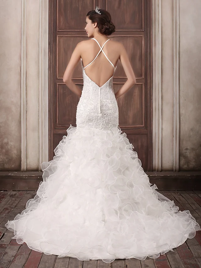 Close-up of intricate beading and cascading ruffles on the bridal gown.