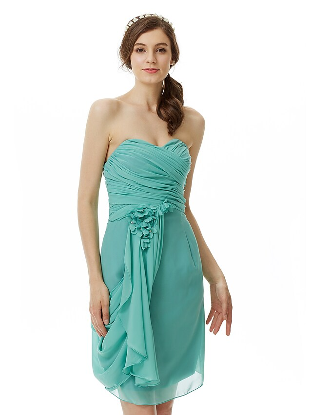 Detail of floral accent on draped chiffon dress.